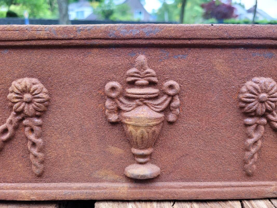 Rusty cast iron jardiniere planter
