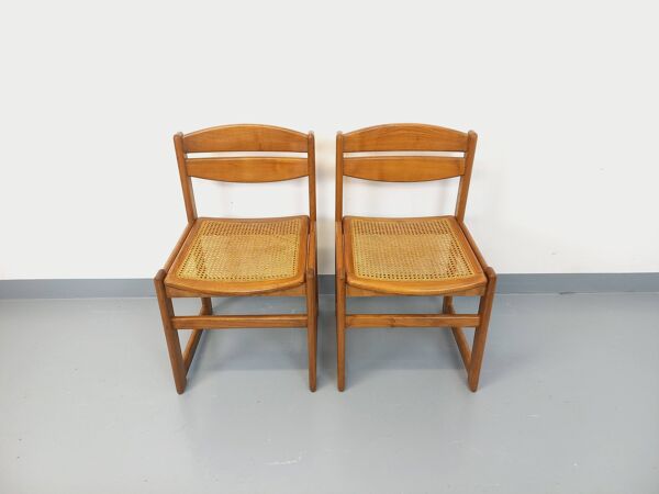 Paire de chaises traîneau vintage en bois de hêtre et cannage des années 70
