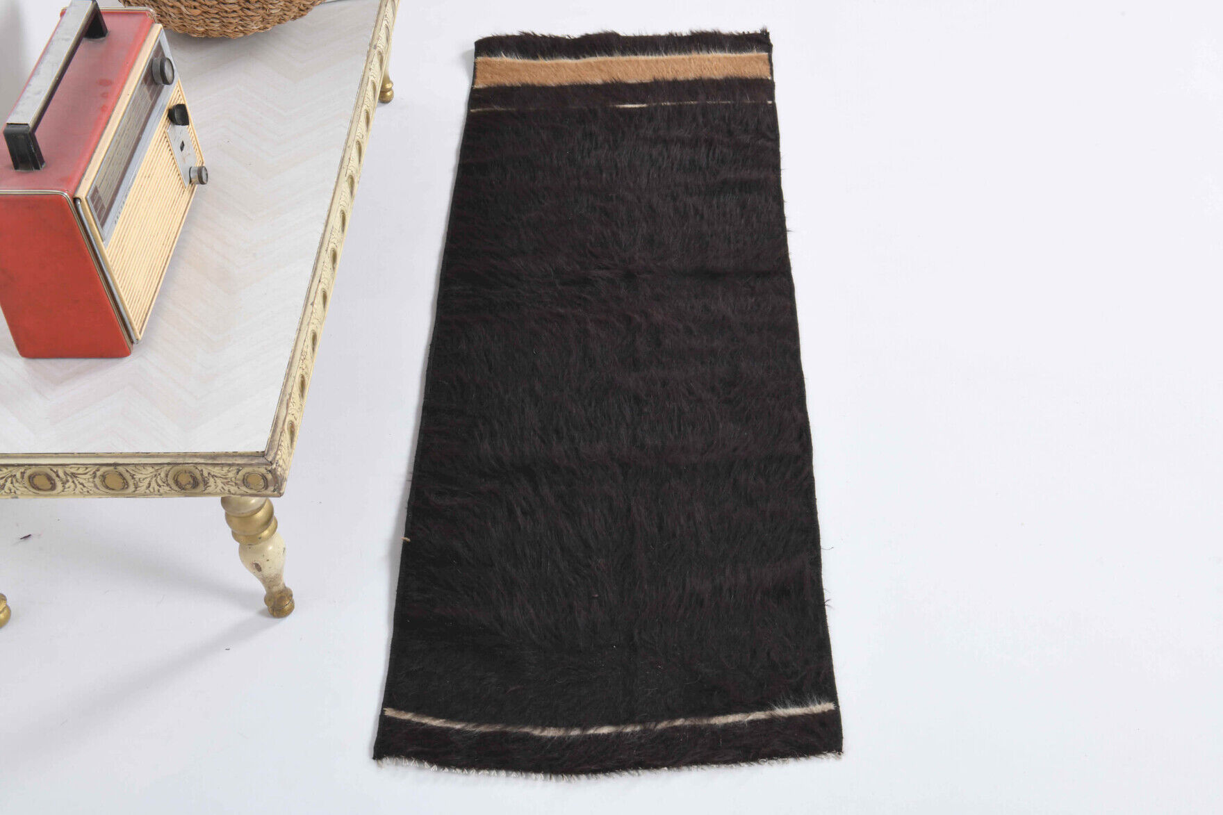 Small vintage flat-woven black rug.