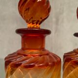 Pair of Baccarat twisted tinted crystal bottles