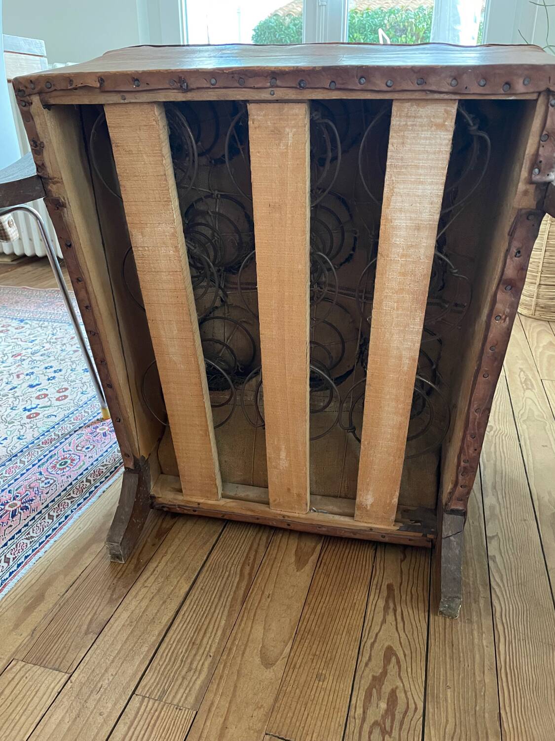 Vintage leather club chair with wooden armrests
