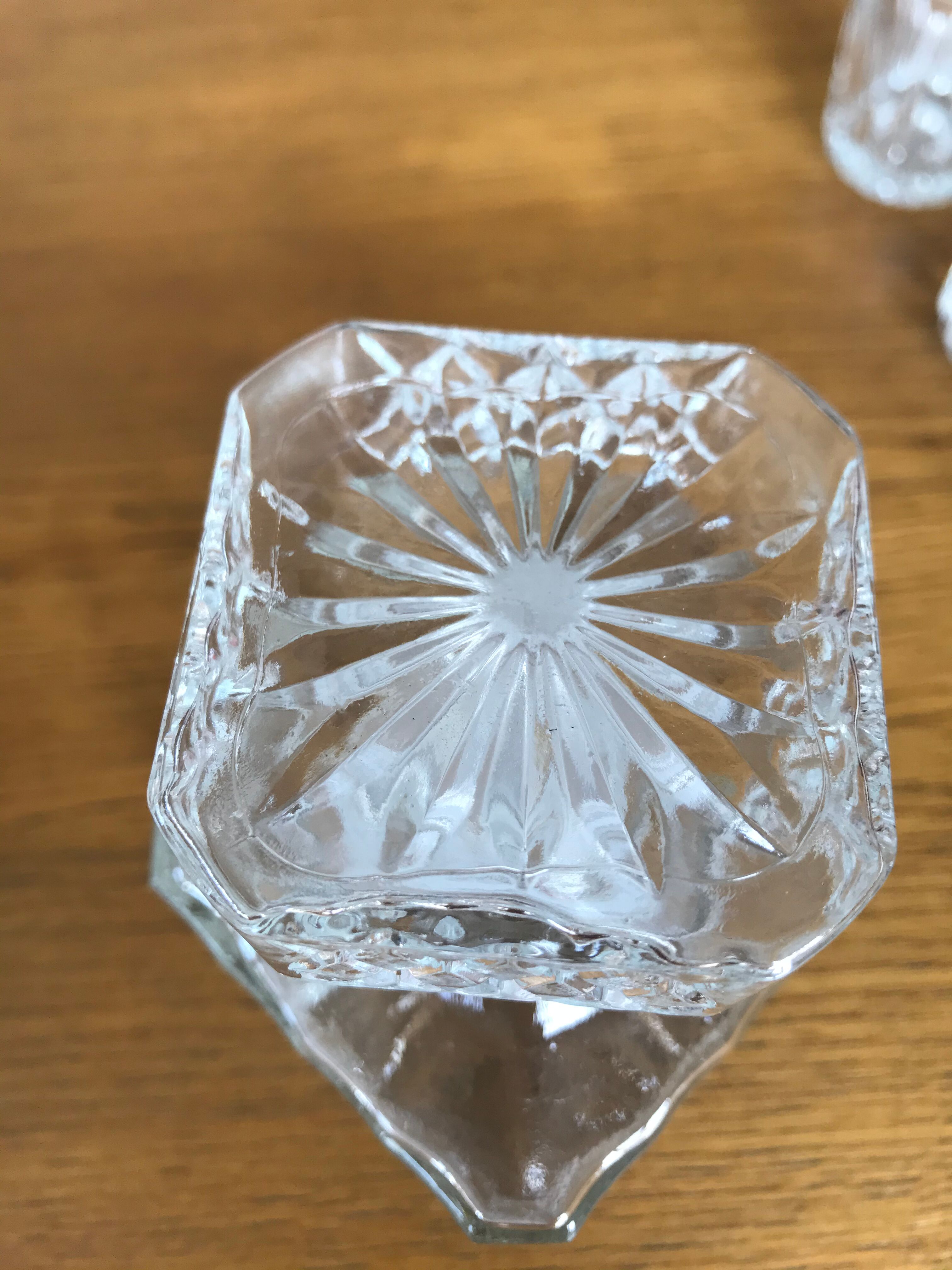 Mismatched decanter and whiskey glasses