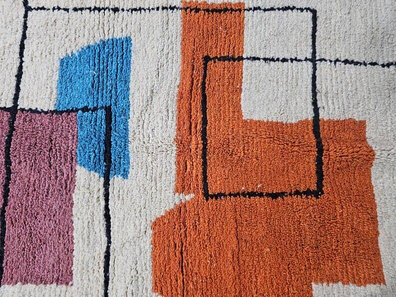 Traditional handmade wool Berber rug with colourful patterns.