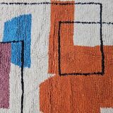 Traditional handmade wool Berber rug with colourful patterns.