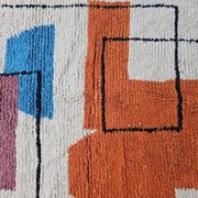 Traditional handmade wool Berber rug with colourful patterns.