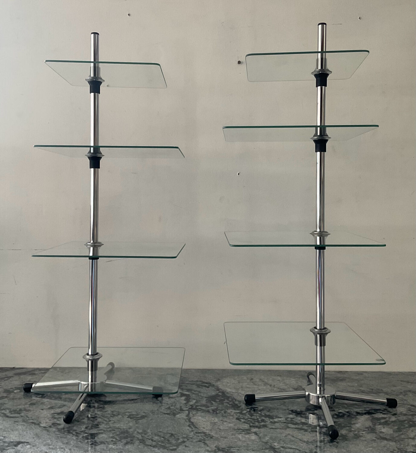 A pair of vintage side tables in glass and chrome metal.