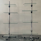 A pair of vintage side tables in glass and chrome metal.