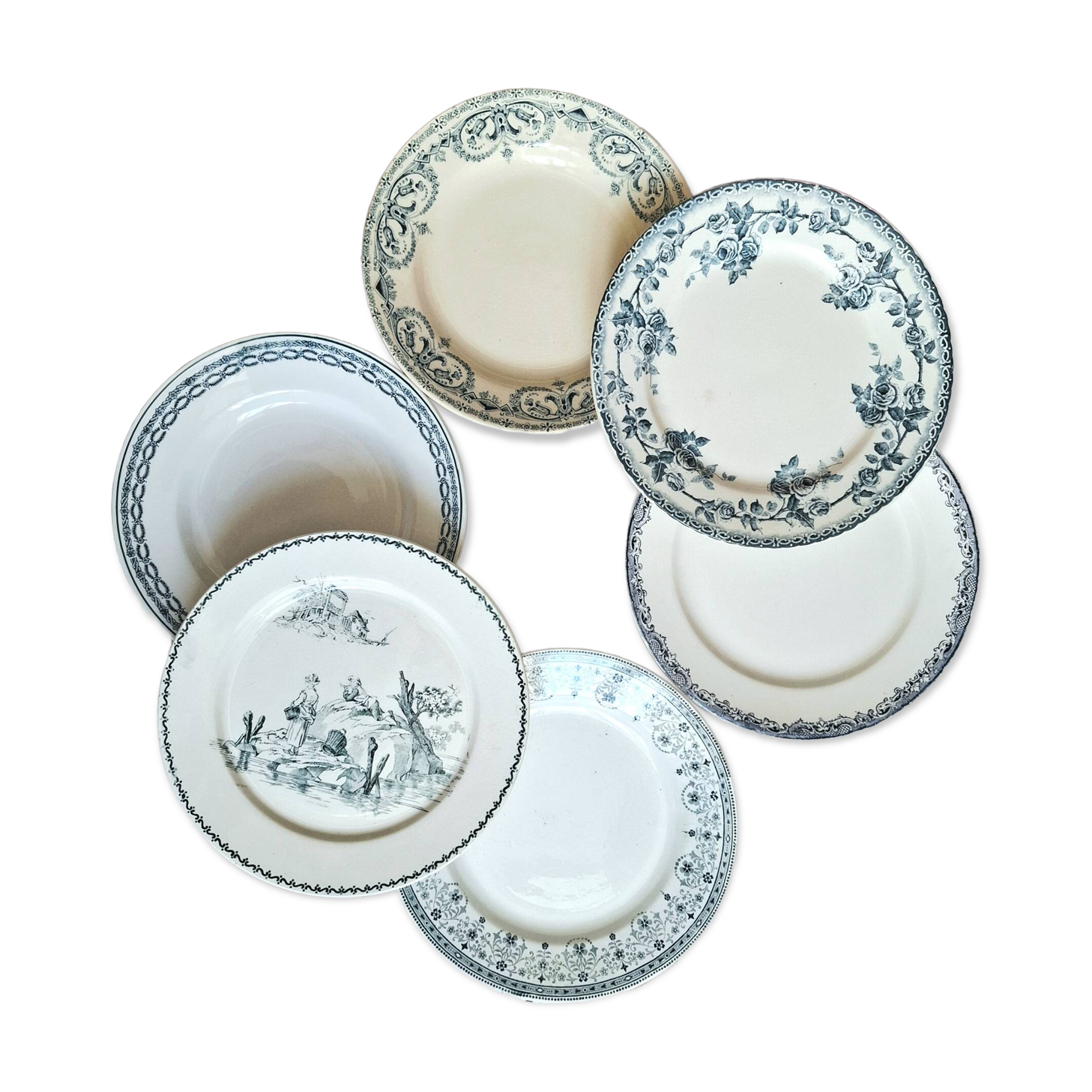 Old mismatched flat plates made of ironstone earthenware.