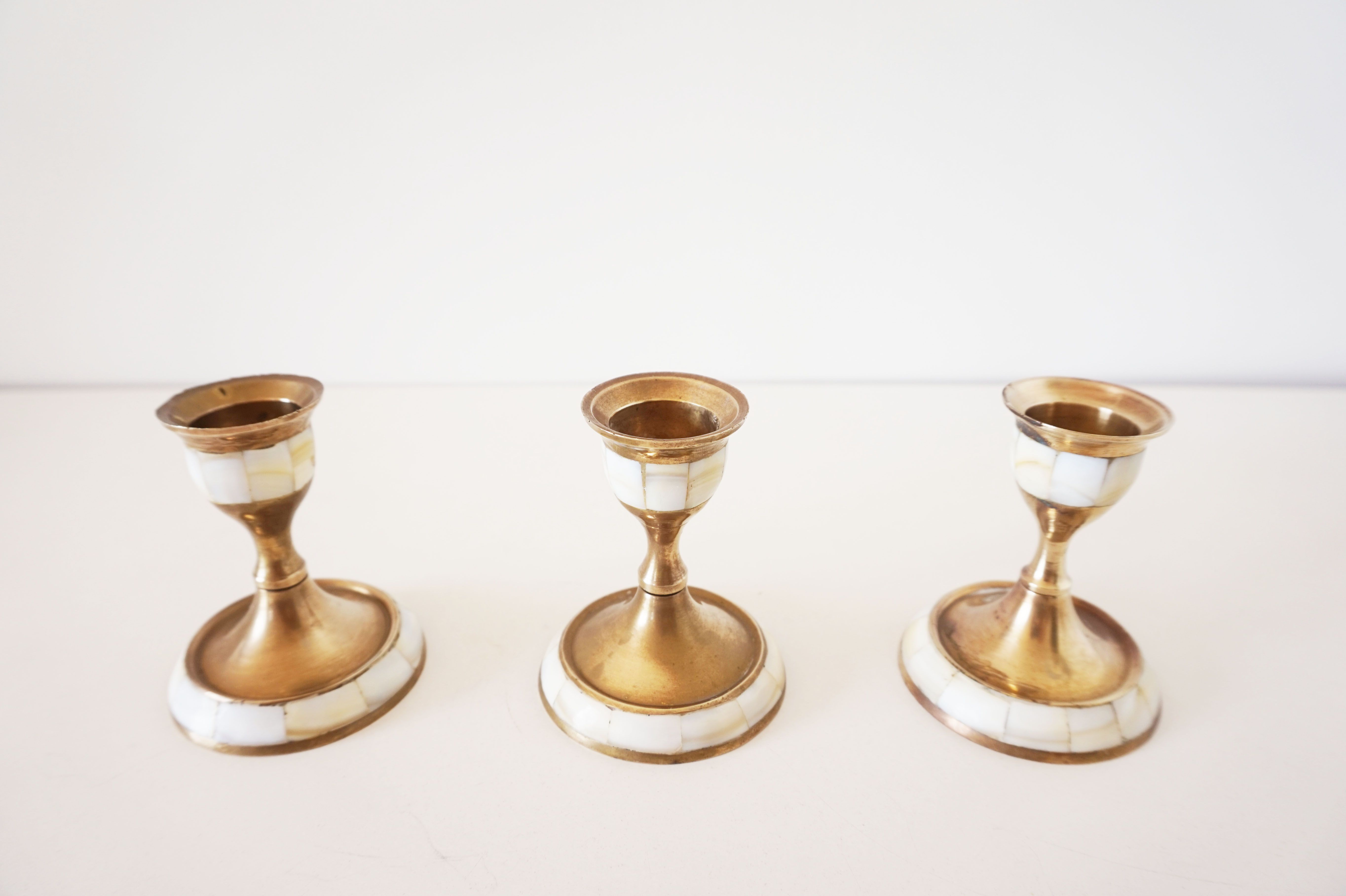 Lot of old candlesticks in brass and mother-of-pearl