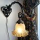 Art Nouveau wall light in wrought iron with vine decoration, early 20th century.