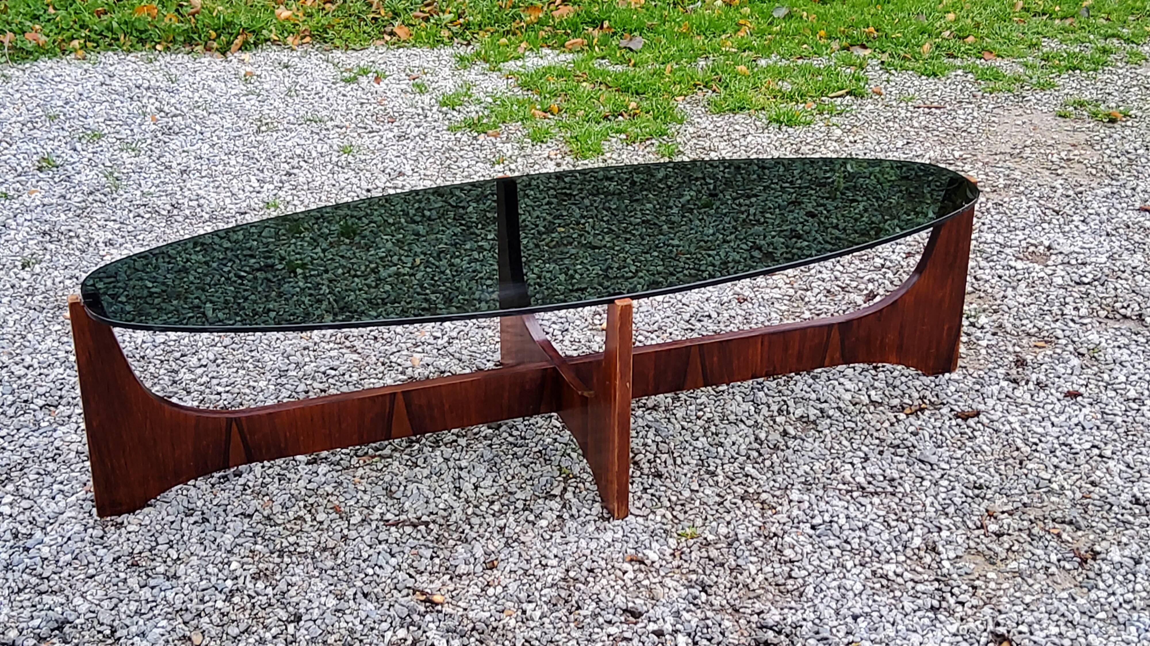 Designer coffee table by Hugues Poignant in rosewood and smoked glass from the 70s