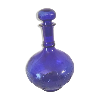 Blue glass carafe decorated grapes