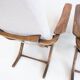 Pair of varnished wooden reclining armchairs, upholstered in lightweight fabric.