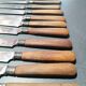 Old table knives and dessert knives, wooden handles, stainless steel blades