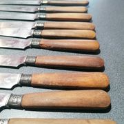 Old table knives and dessert knives, wooden handles, stainless steel blades