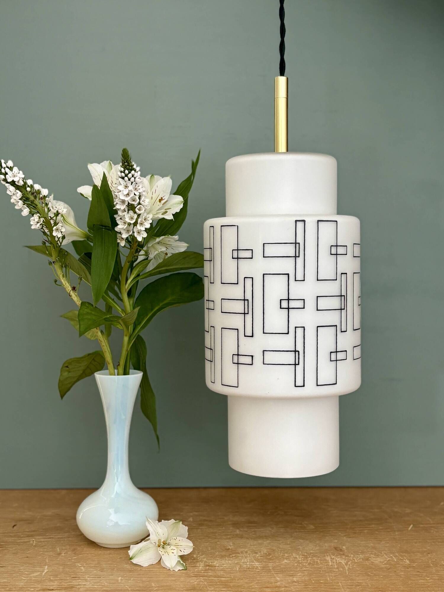 Vintage suspension globe in white opaline with black drawings.