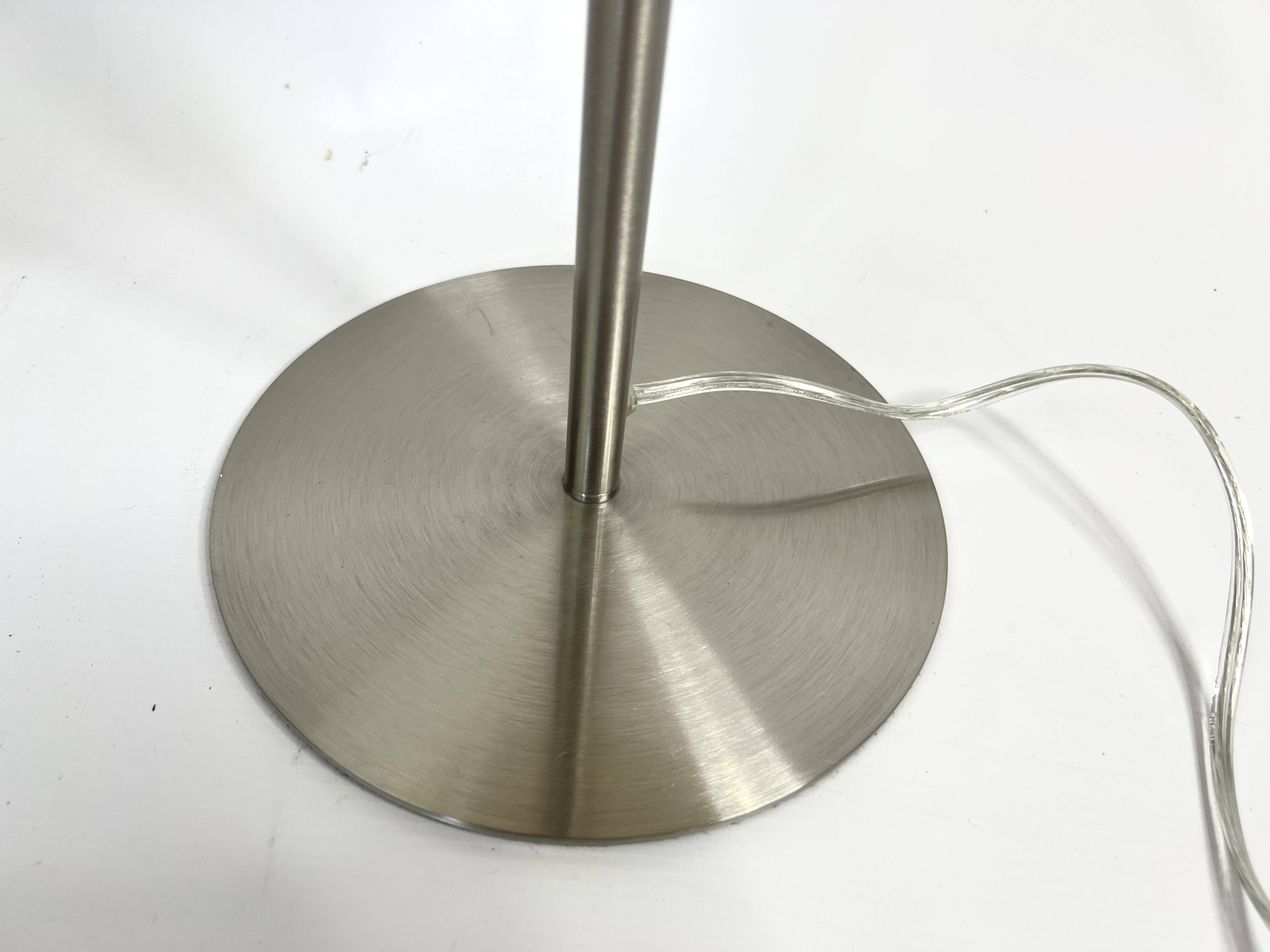 Pair of large brushed metal lamps with cream shades.