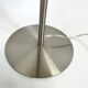 Pair of large brushed metal lamps with cream shades.