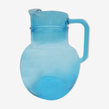 orange pitcher in turquoise blue glass