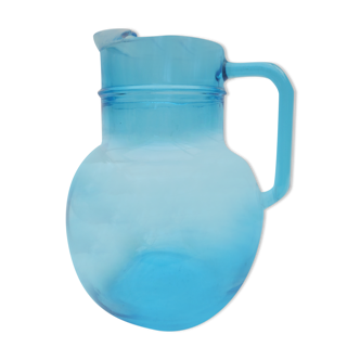 orange pitcher in turquoise blue glass