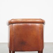 Cognac-colored cow leather club chair finished with decorative nails in English style