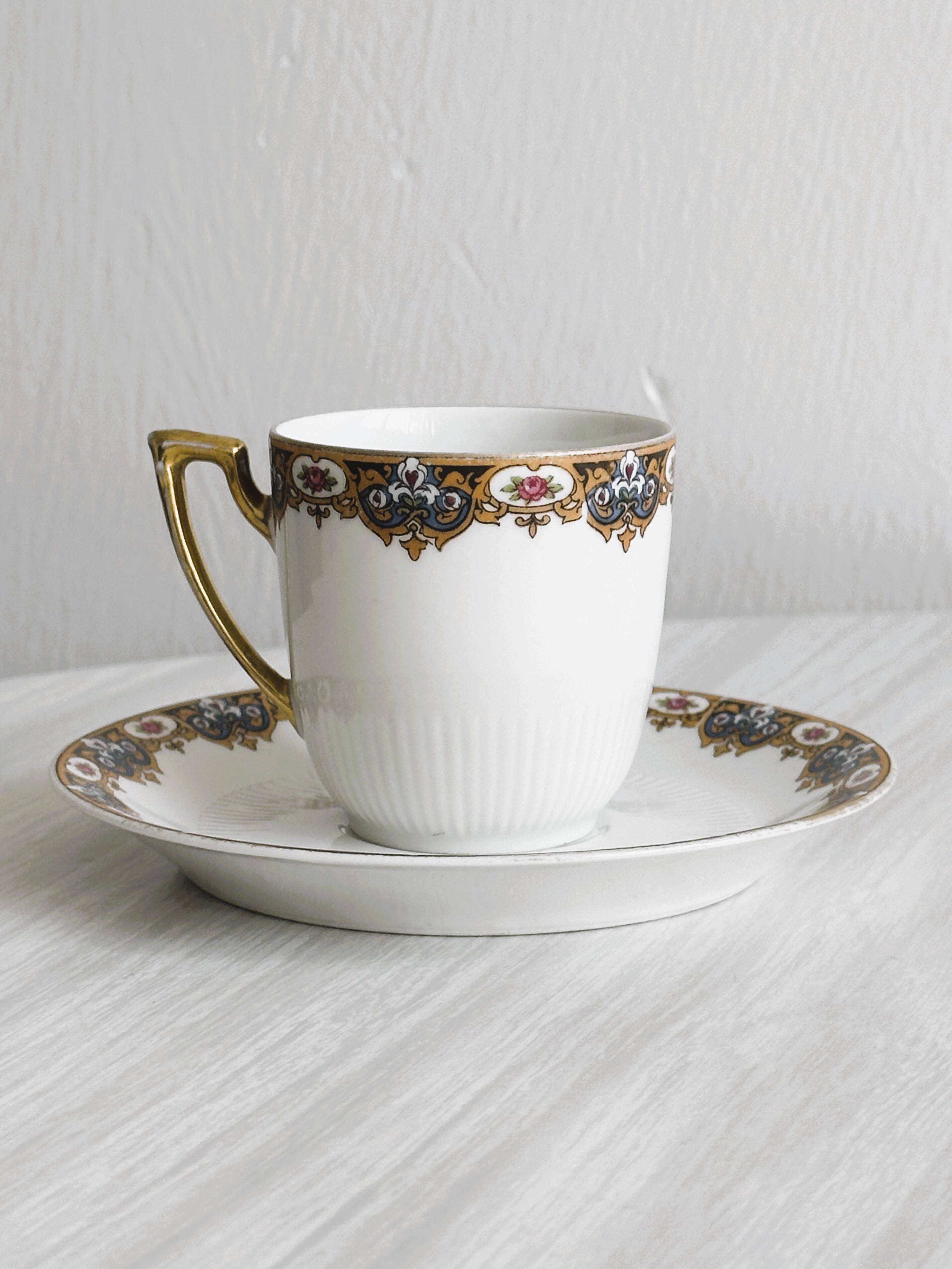 7 Limoges porcelain cups and saucers with gold decoration and floral motif.