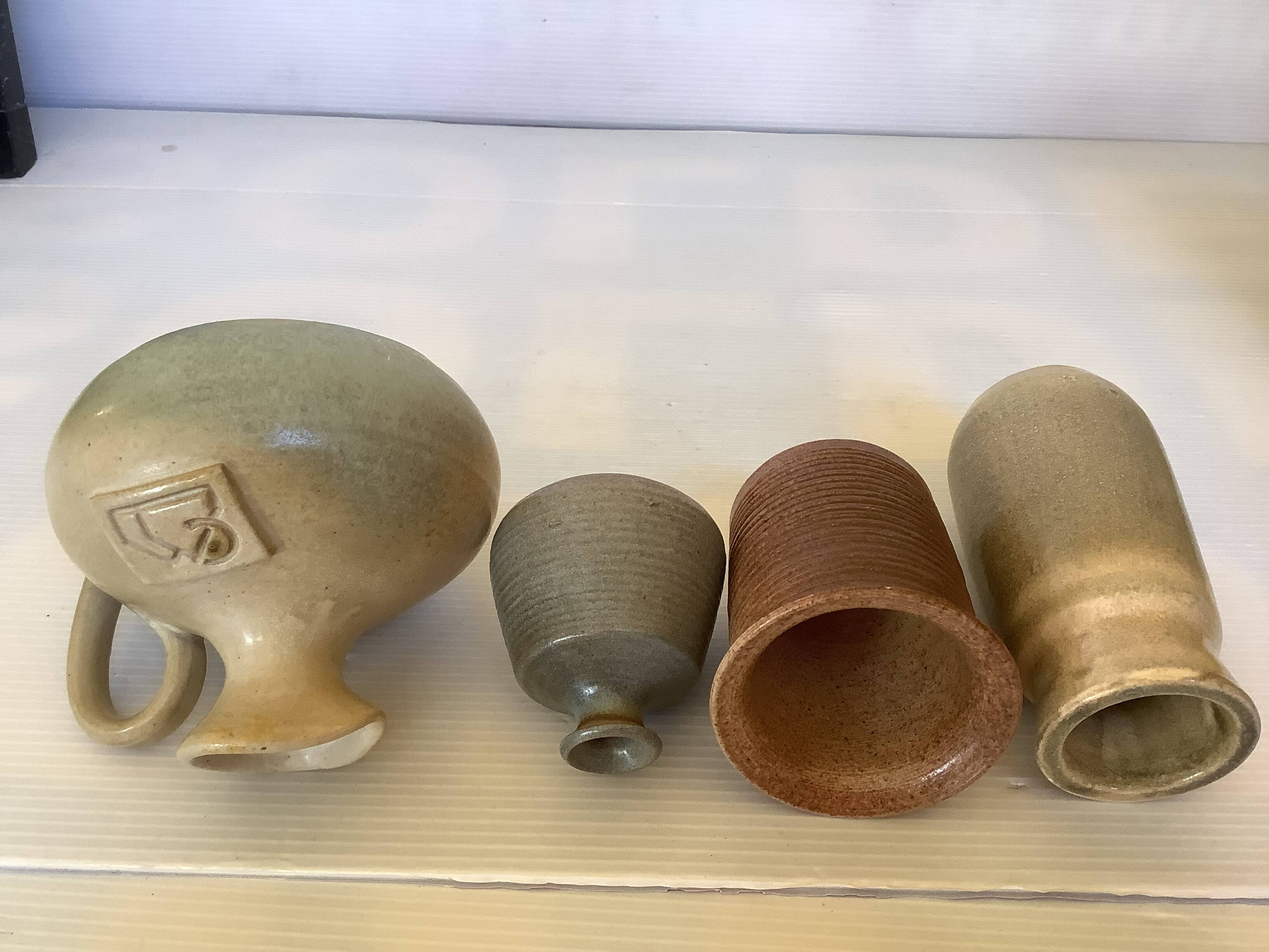 Seven beige and gray ceramic vases