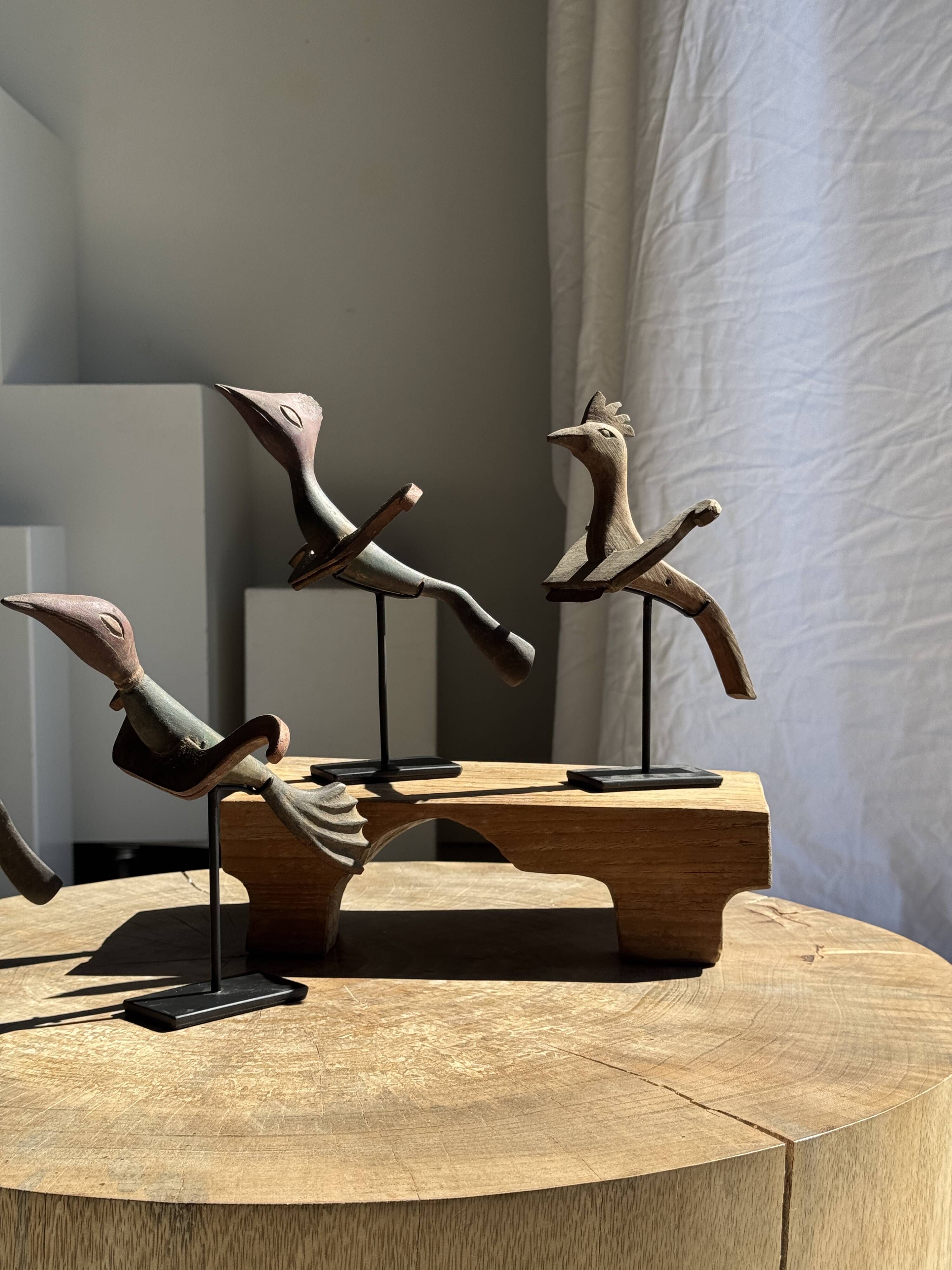 Traditional Indonesian decorative wooden bird on a base, crest model.