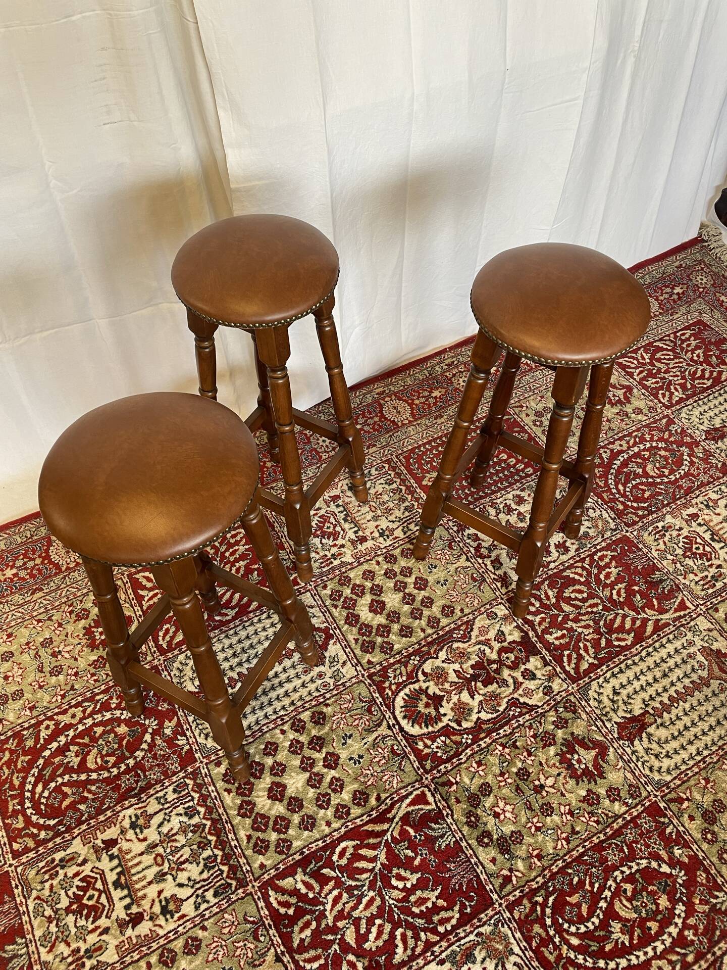 Set of 3 antique wooden and leather bar stools.