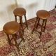Set of 3 antique wooden and leather bar stools.
