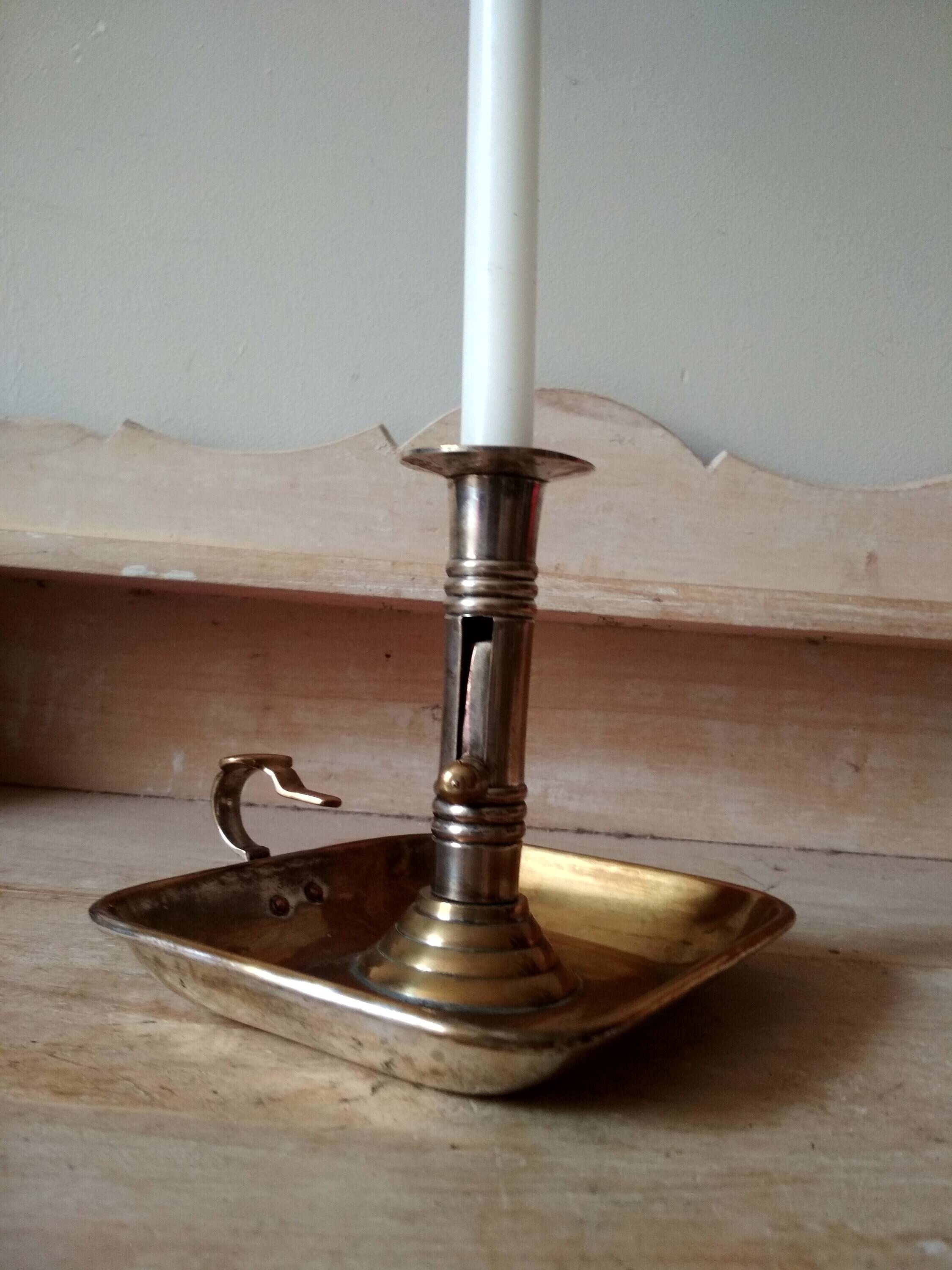 Antique metal and brass hand candle holder on rectangular base