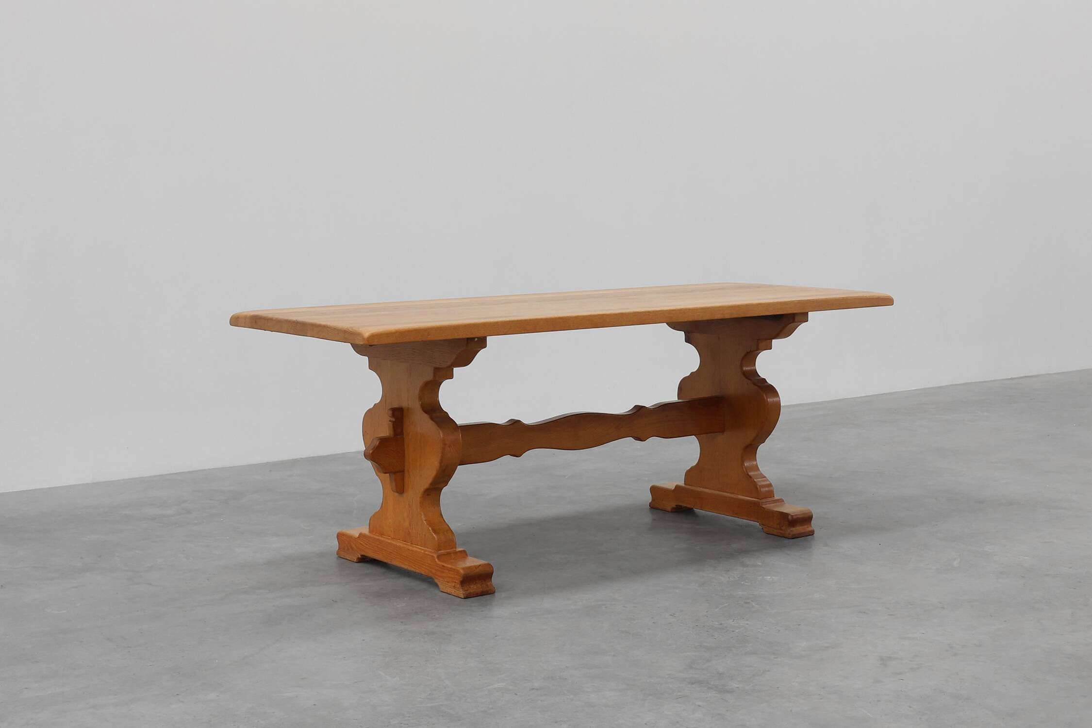 20th Century French oak trestle table with scalloped legs and plank top