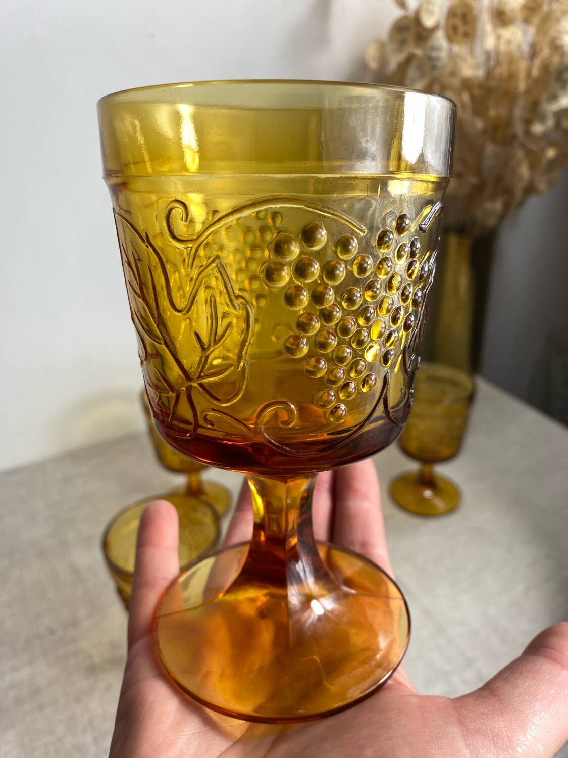 Six stemmed glasses in amber-colored molded glass