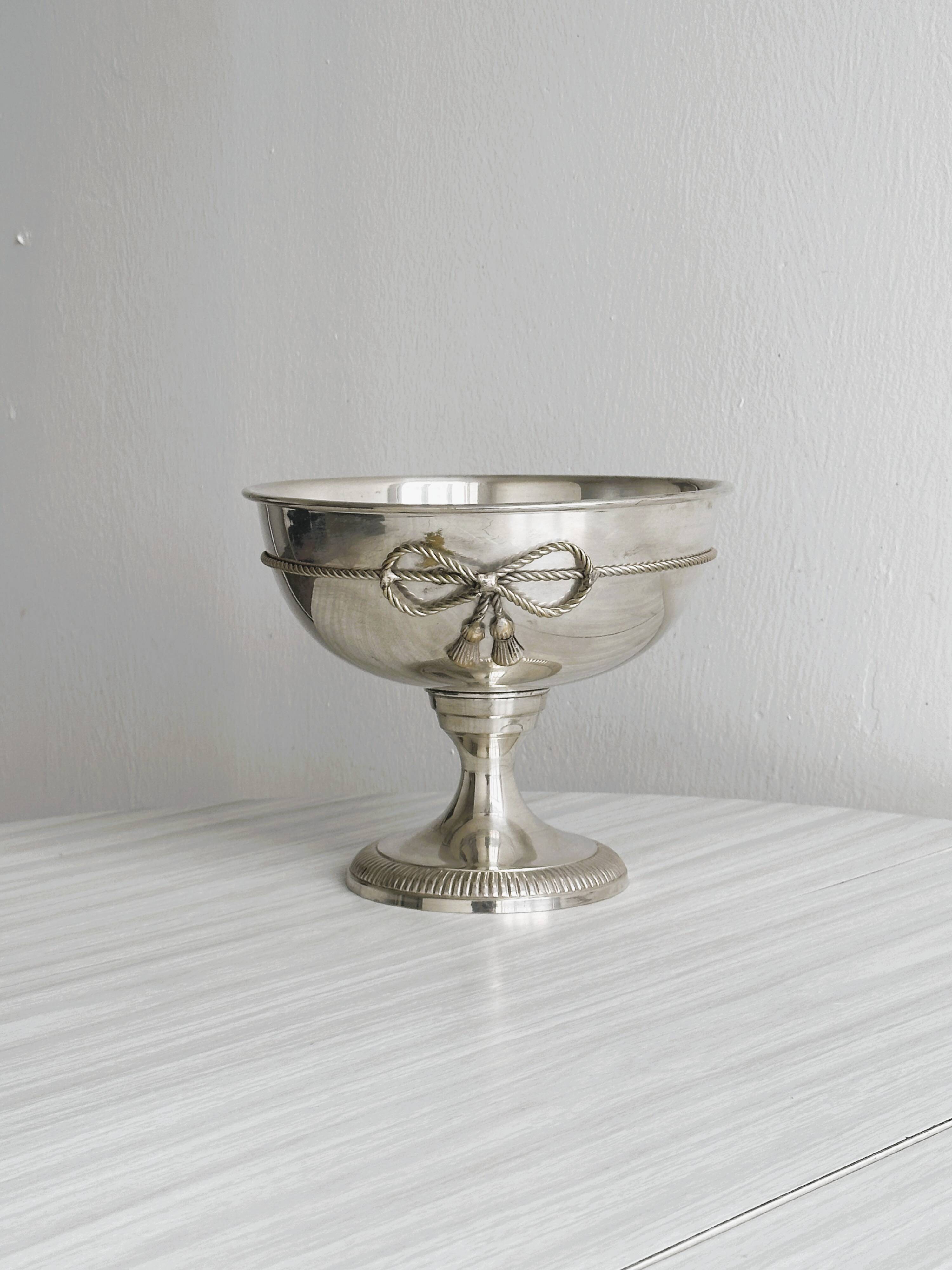 shiny silver metal cup on foot