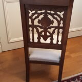 Prie-god furniture in the shape of a low seat with an armnedle on which one kneels to pray