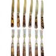 Table art, 12 fruit cutlery sets in gilded metal with horn from the early 20th century.