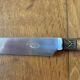 Service of 24 Art Deco knives with wooden handles and engraved metal ferrules from 1930.