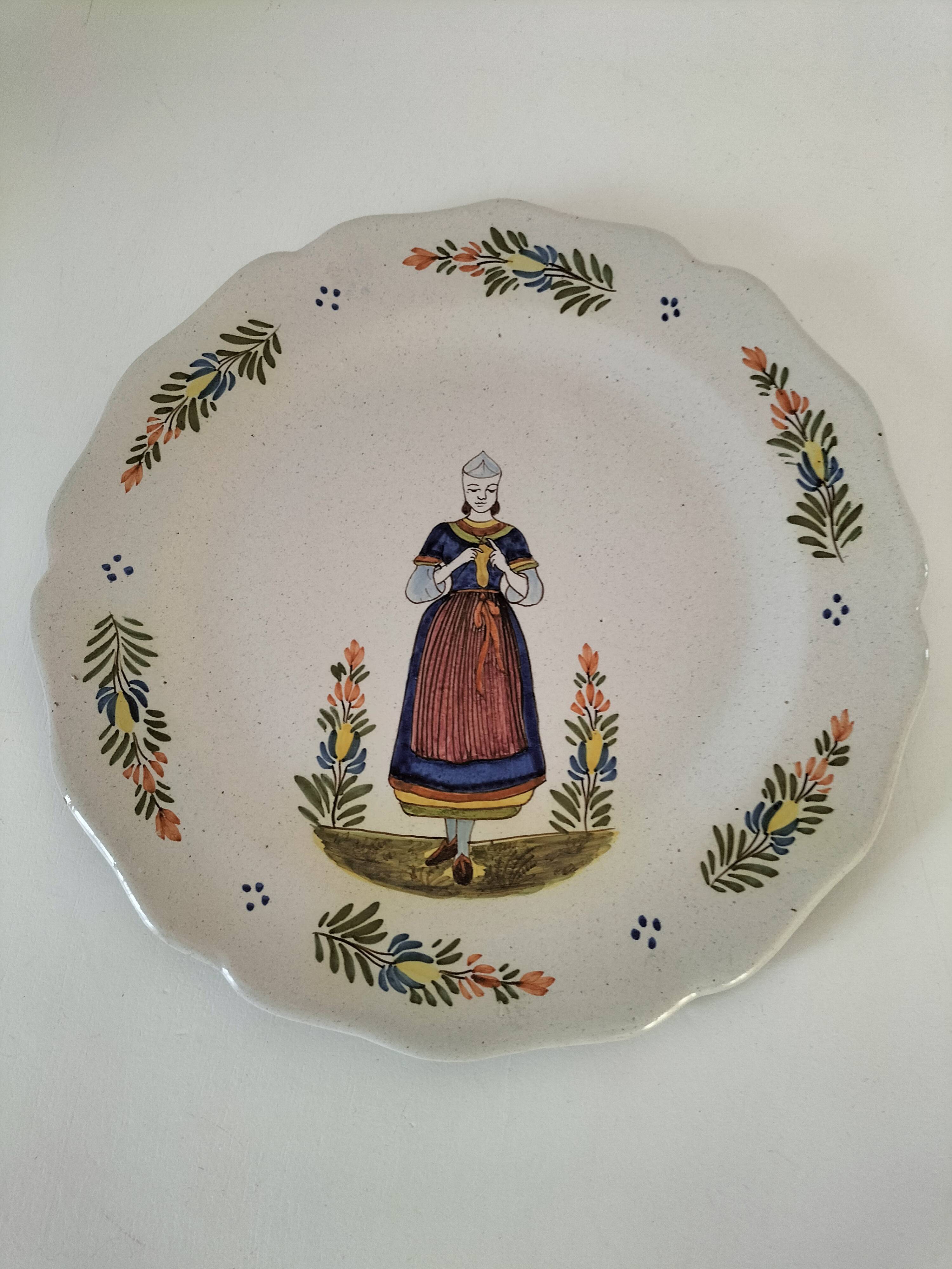 Hand-painted Breton plate, decorated with a woman knitting, 1950s