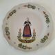 Hand-painted Breton plate, decorated with a woman knitting, 1950s