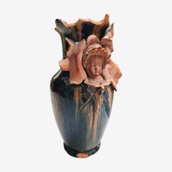 Terracotta vase with a child's head