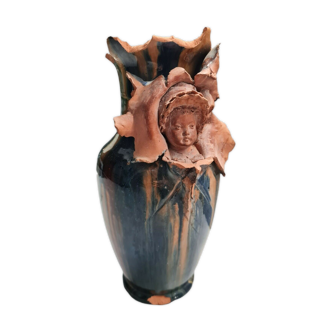 Terracotta vase with a child's head