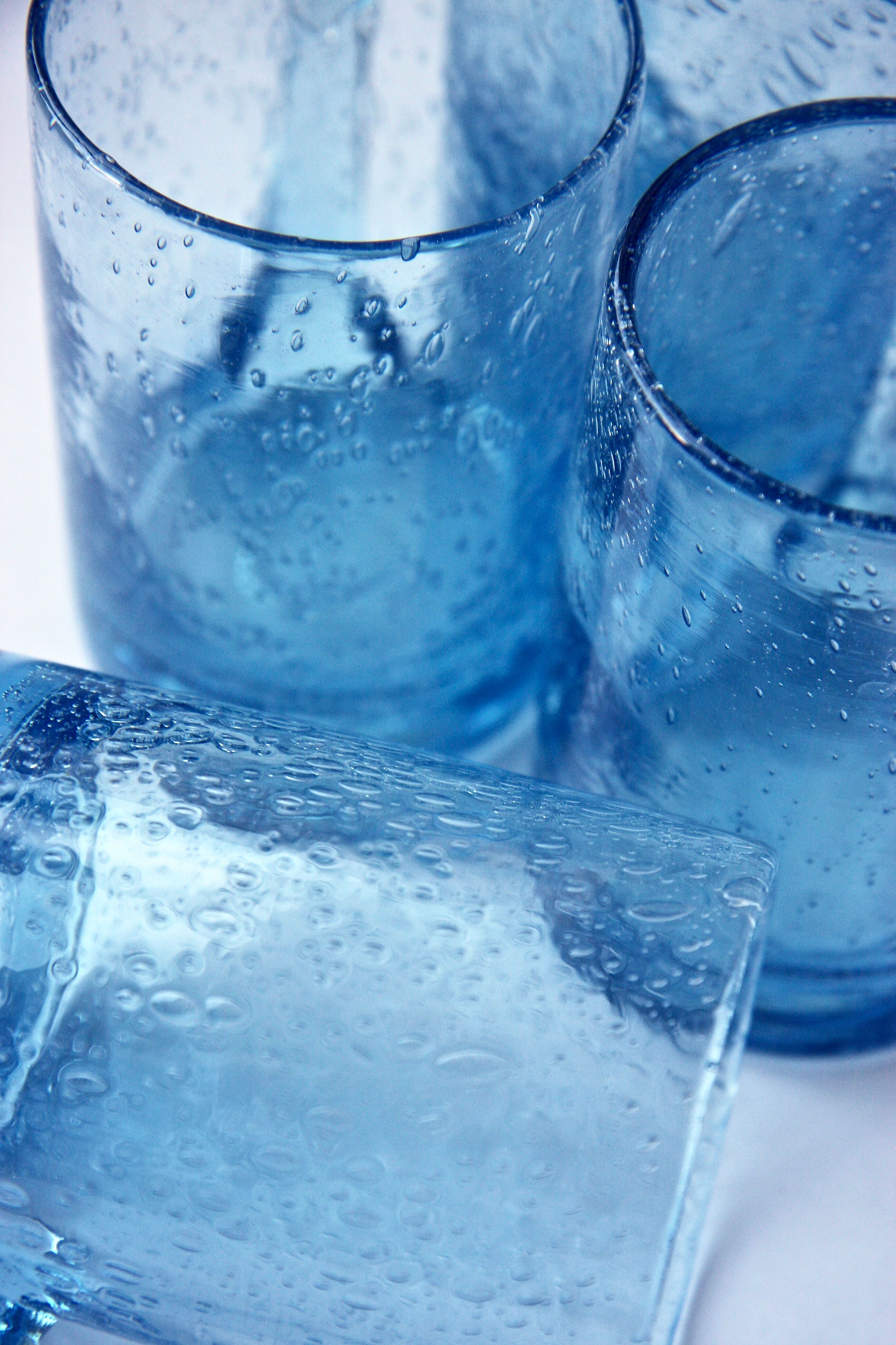 Four Biot glass mugs blue bubbled glass