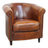 Sheep leather club chair in a cognac color and finished with piping