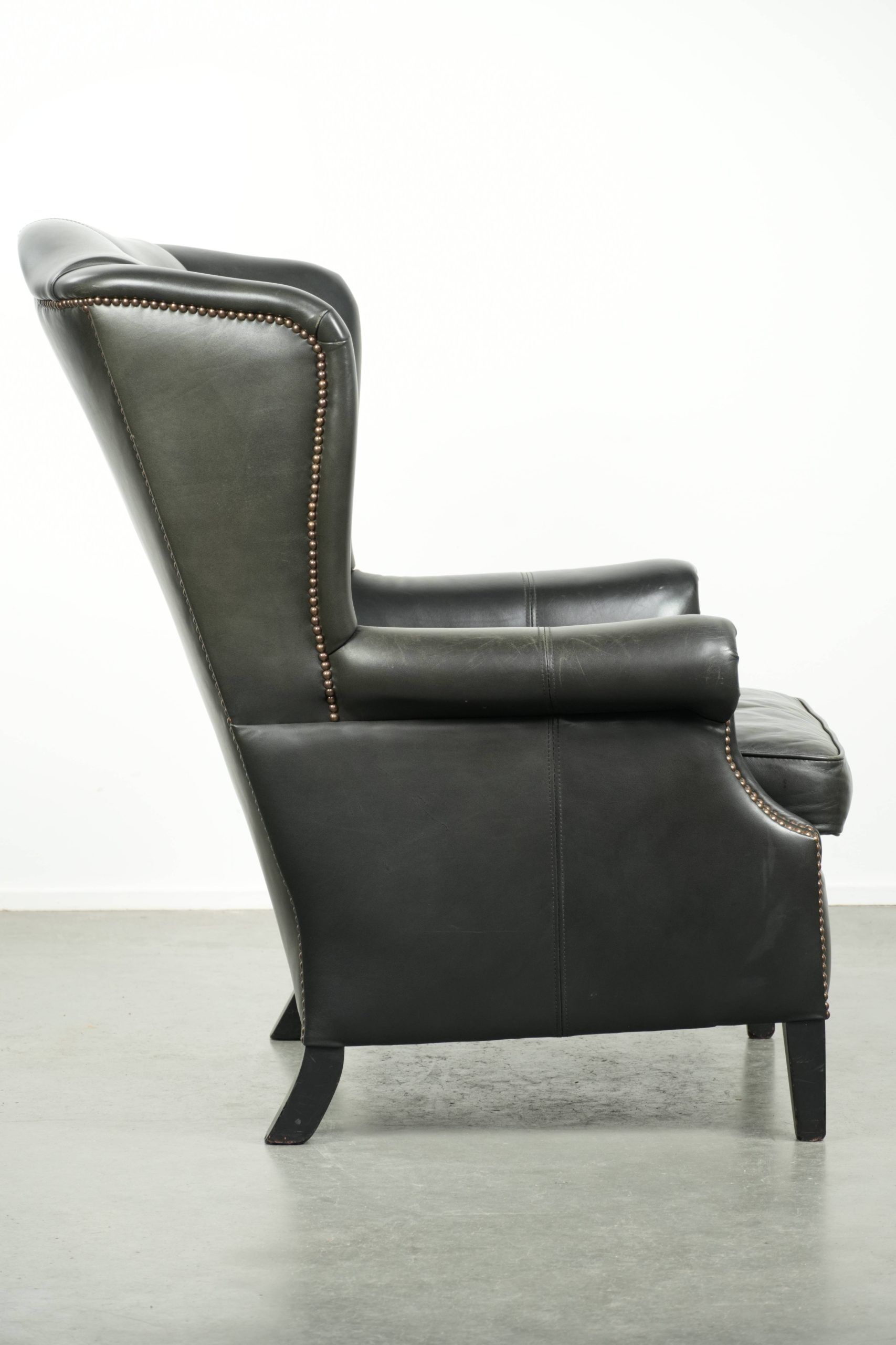 Black cowhide wingback armchair in classic English style