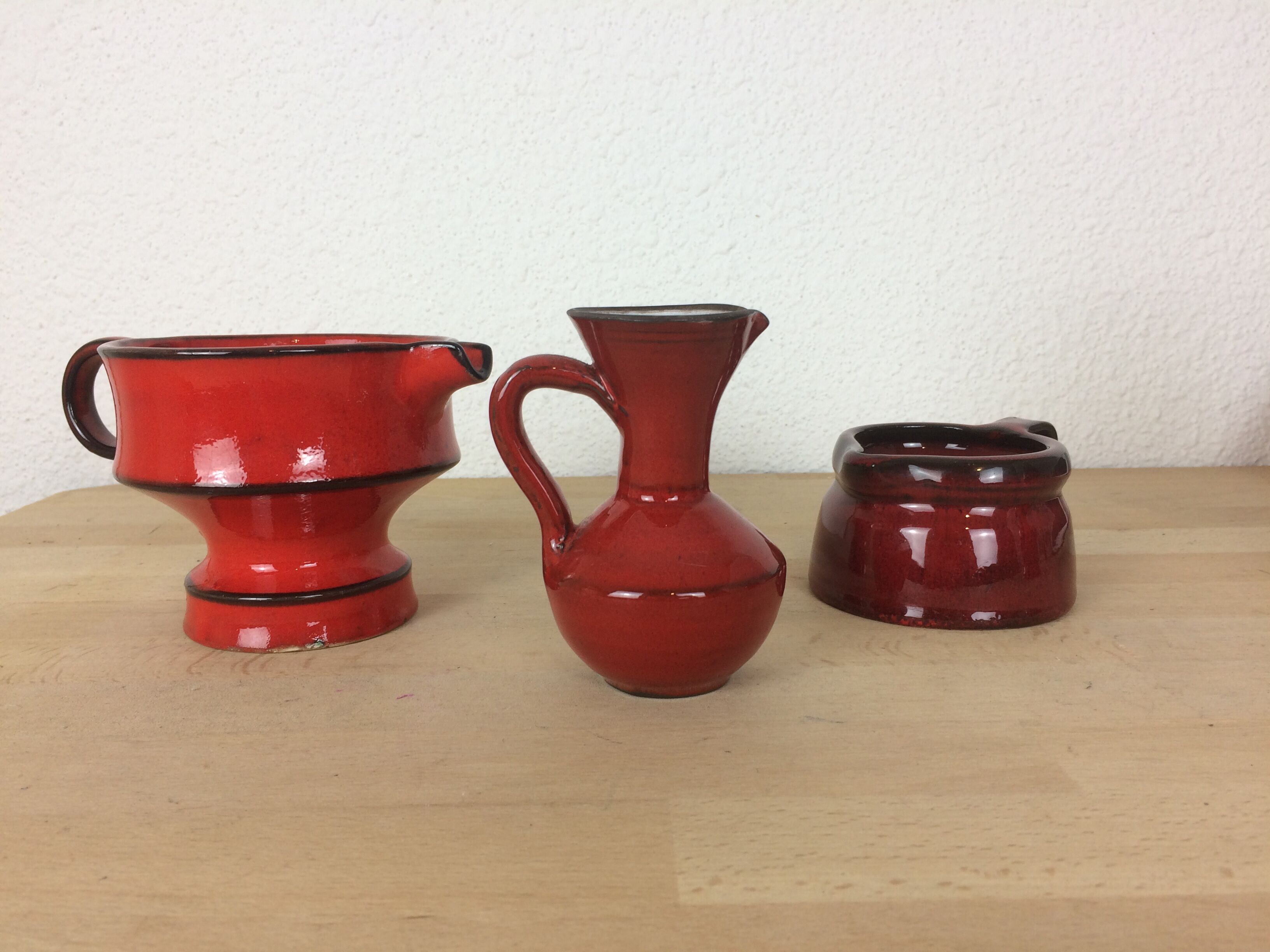 3 red ceramic vases