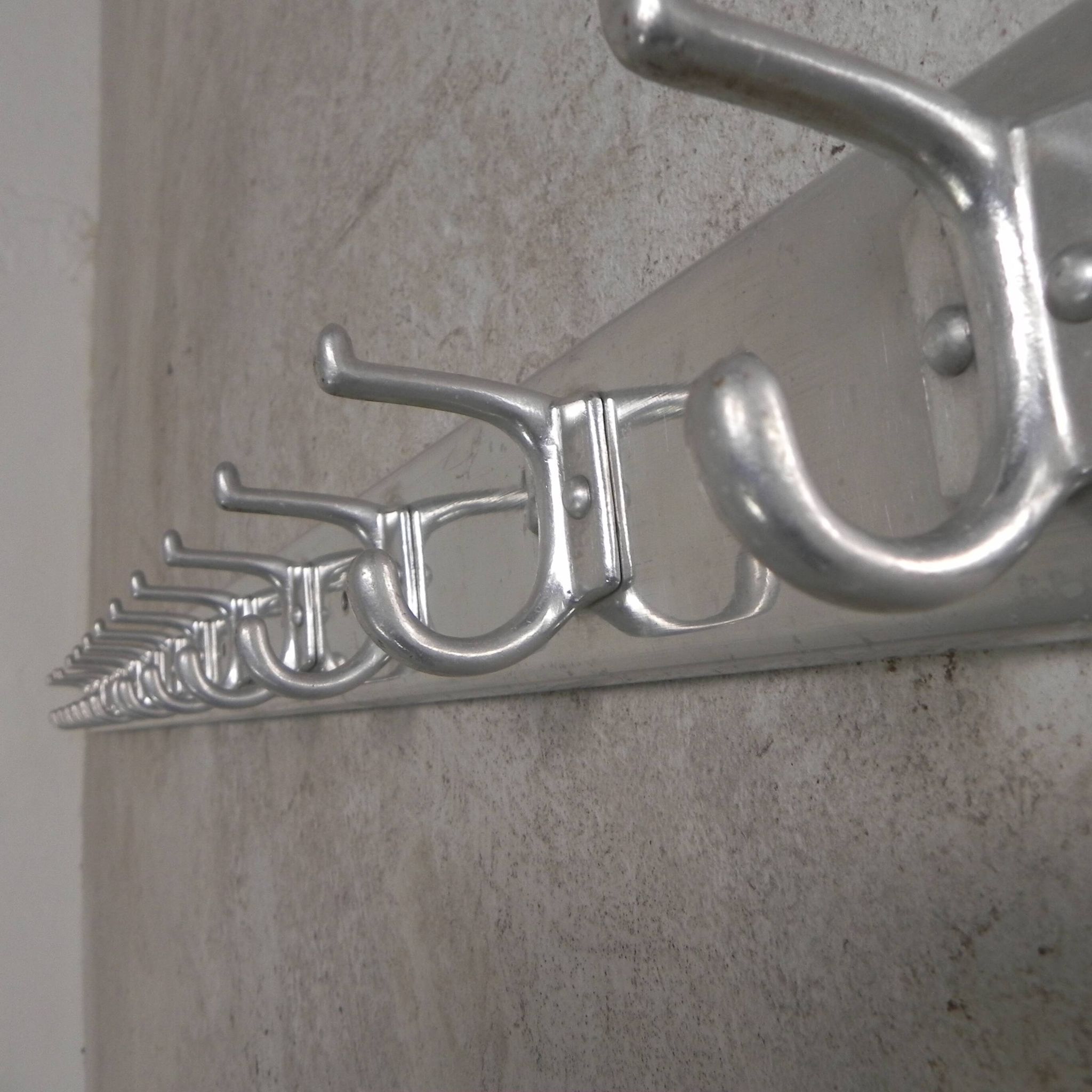 Wall-mounted aluminium coat rack of 225 cm with 16 double hooks, 1960s.