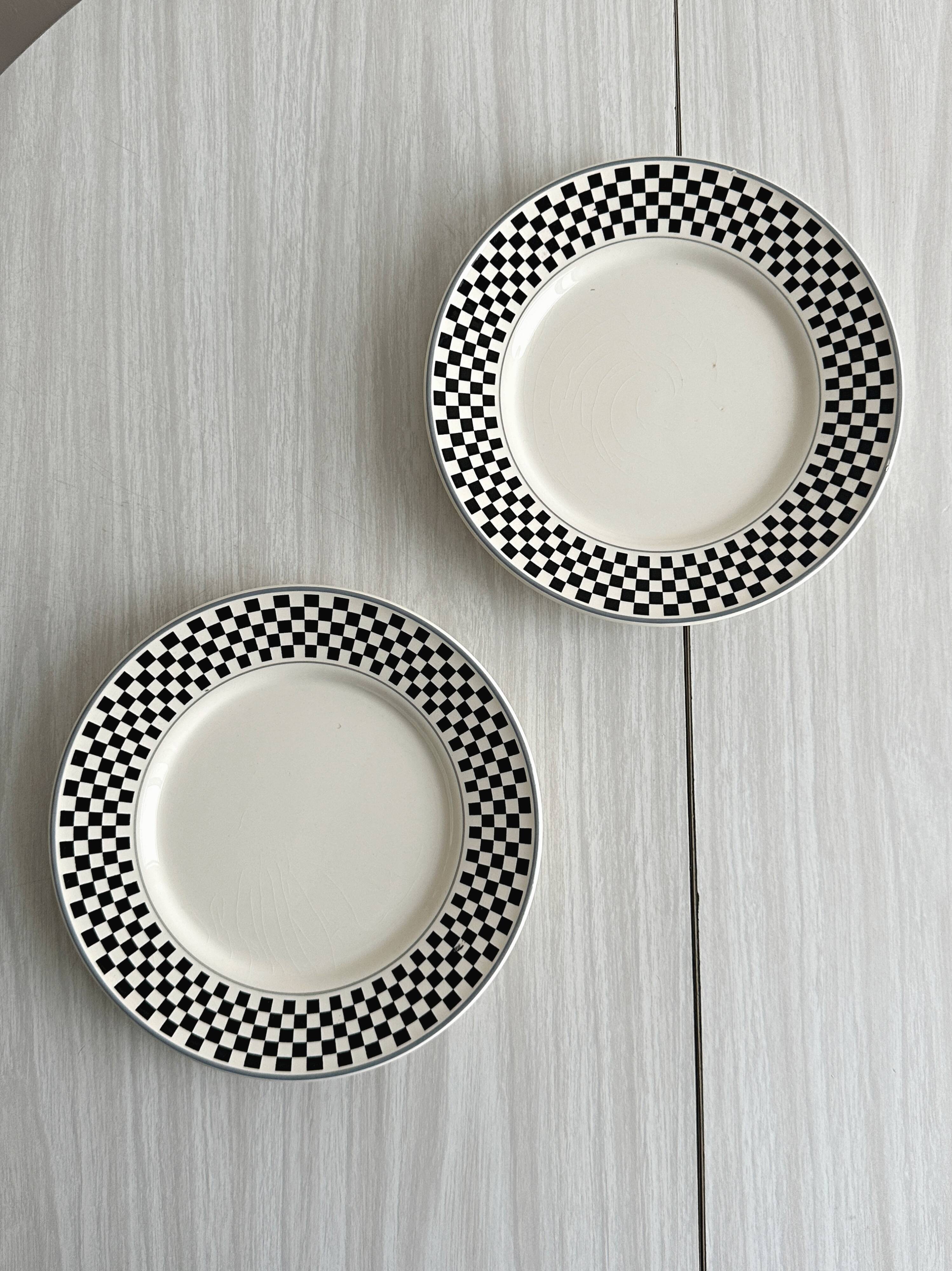 Pair of vintage plates with a black and white checkered pattern.