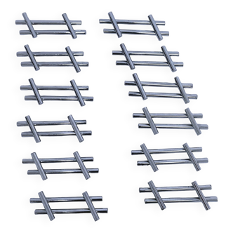Twelve 70s design metal knife holders