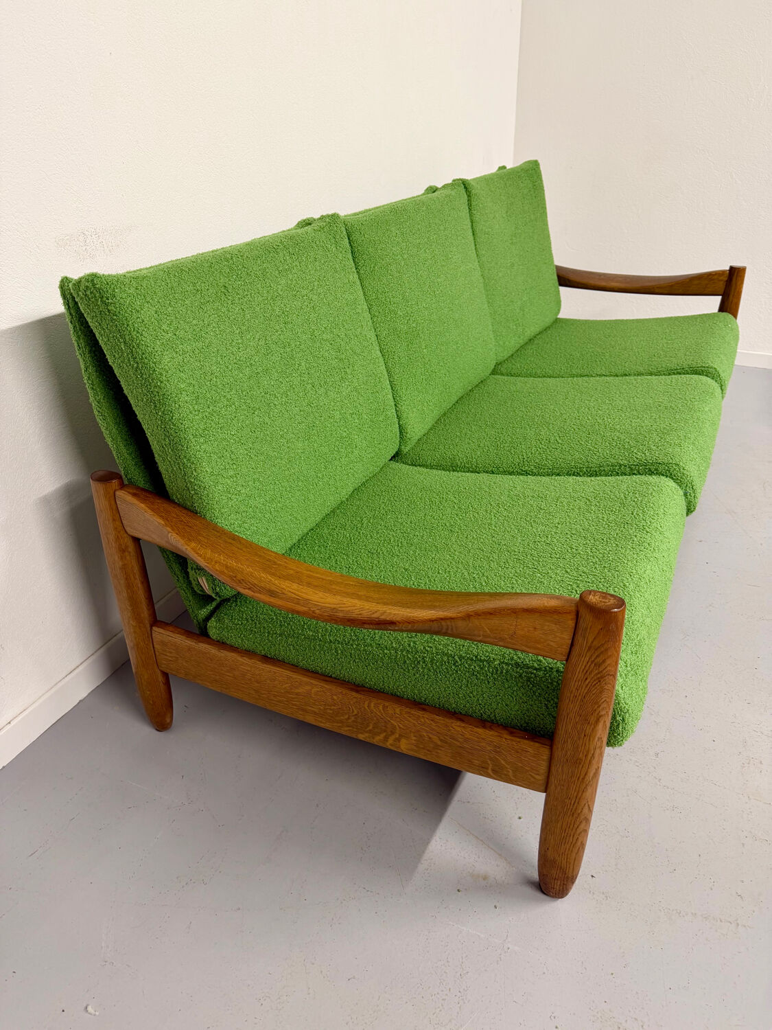 Living room sofa and Scandinavian design armchairs from the 1960s in green boucle.