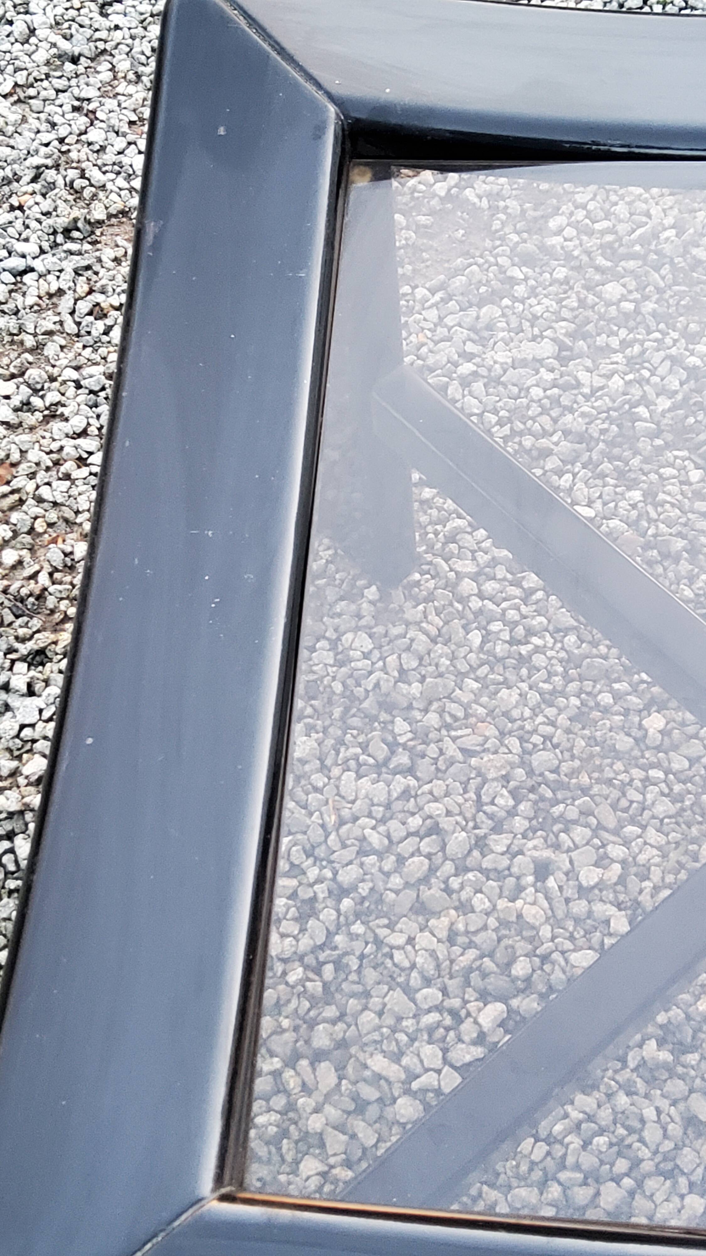 70s design coffee table in black lacquered wood with smoked glass top